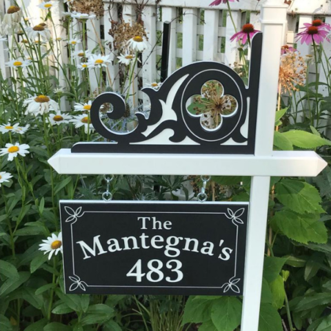 Custom black-white-black engraved house number sign with family name and decorative accents, plus engraved celtic corner