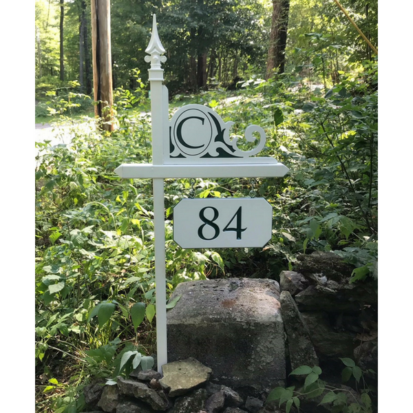 Custom green and white engraved sign with house number and custom engraved monogram corner on one of our white lawn sign holders