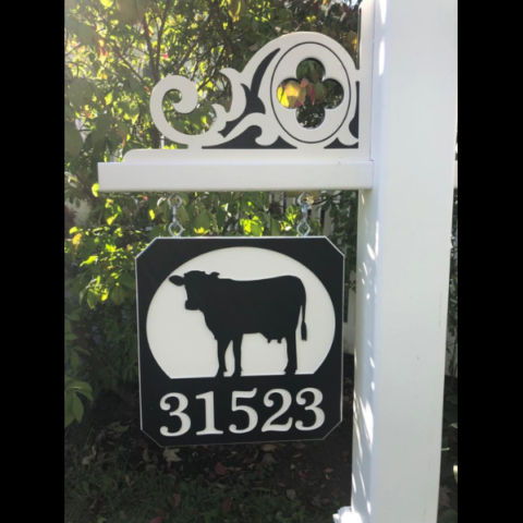 Engraved cow sign with 5 numbers on black-white-black color core and celtic corner accent