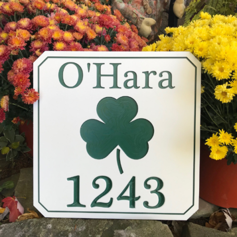 Engraved shamrock sign with last name and house number using white-green-white color core