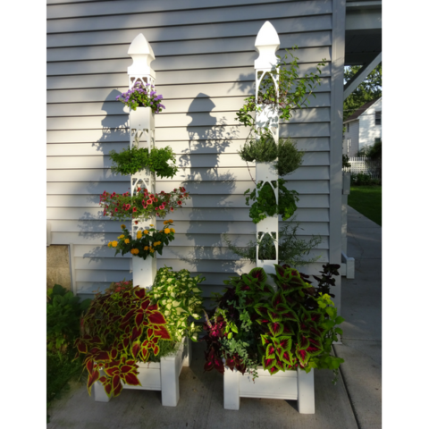 Two planted Flower Towers, side by side in patio bases