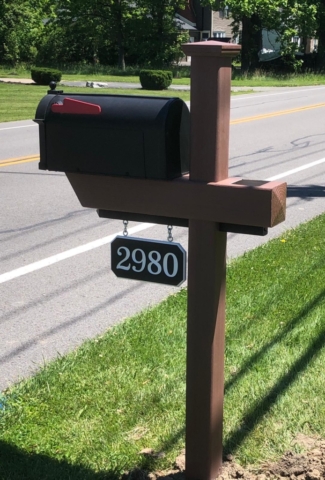 Essential Woodgrain Mailbox Post in Brazilian Blend with custom black-white-black engraved house number sign.
